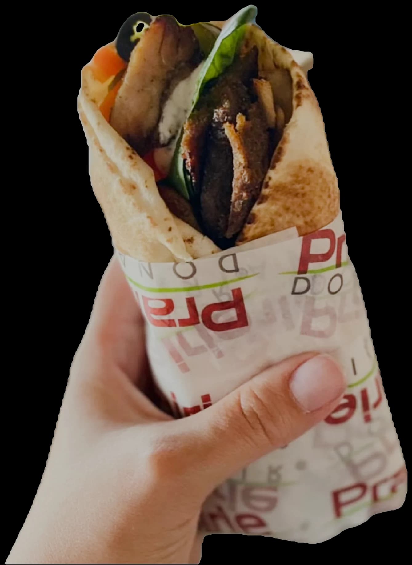 A Prairie Donair donair — grilled seasoned beef, fresh vegetables and sauce folded into warm flatbread — held in hand in branded wrapping paper.